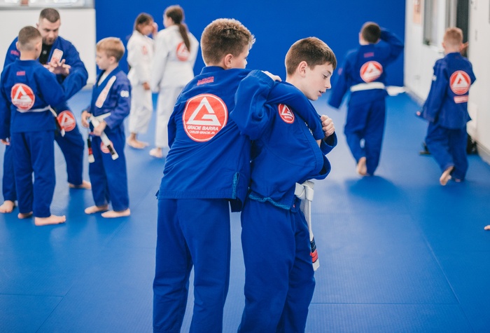 Two children practising a standing partner drill in Brazilian Jiu-Jitsu
